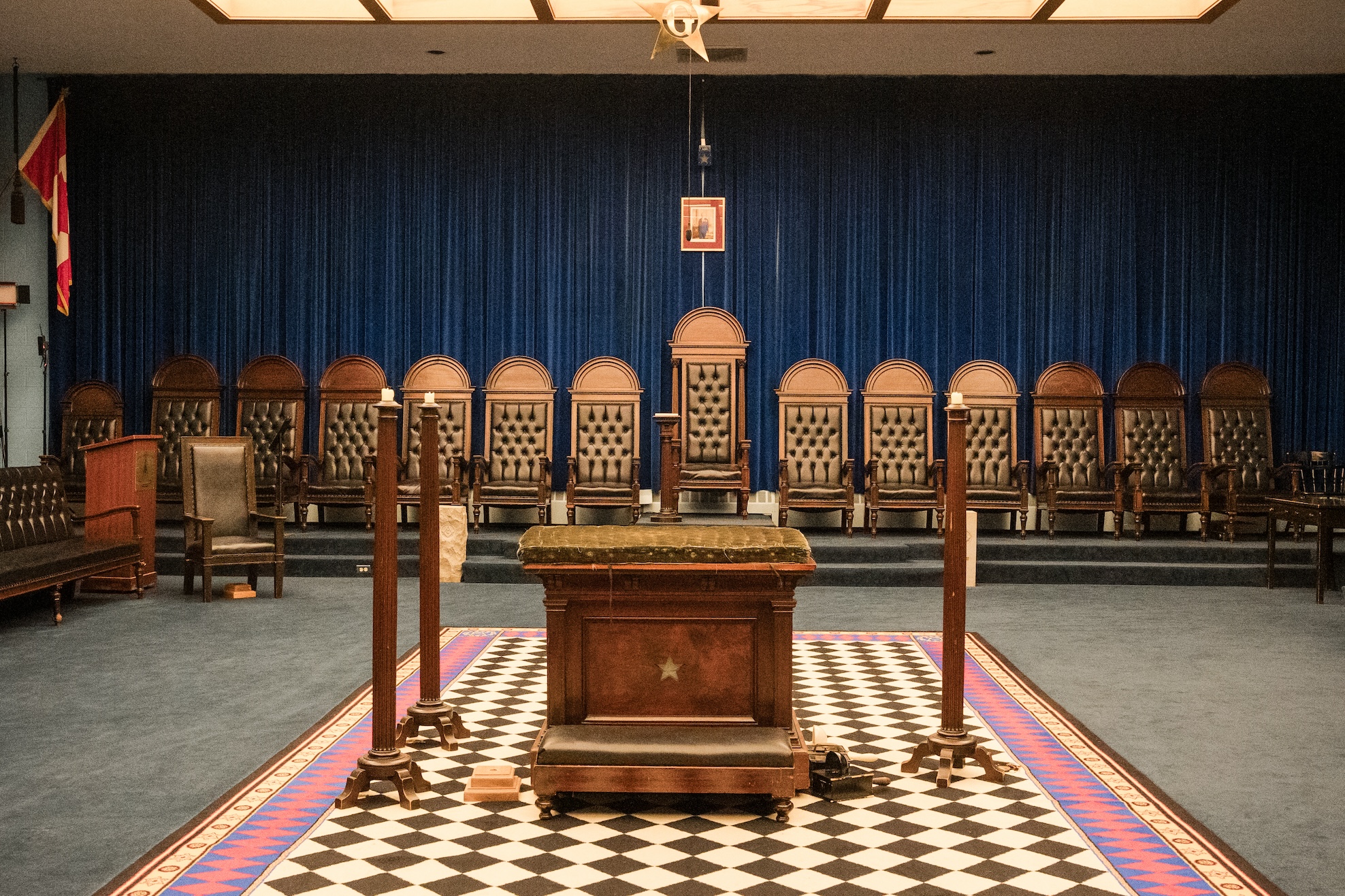Ottawa District 2 Freemasons lodge room featuring the East with ceremonial chairs, blue velvet backdrop, and the black-and-white Masonic mosaic pavement